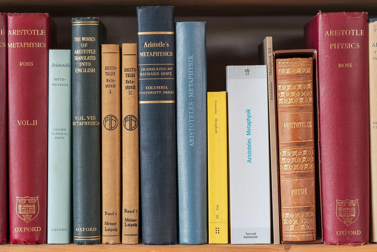 A row of books on a wooden shelf