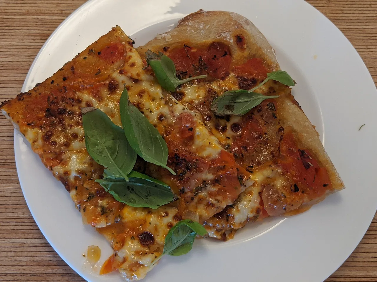 Margherita pizza with tomato, cheese and basil on a white plate